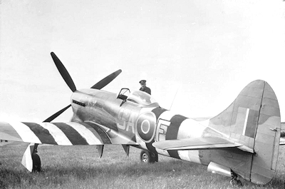 ​Squadron Leader J H Iremonger of No. 486 Squadron,  standing by a Hawker Tempest in 1944
